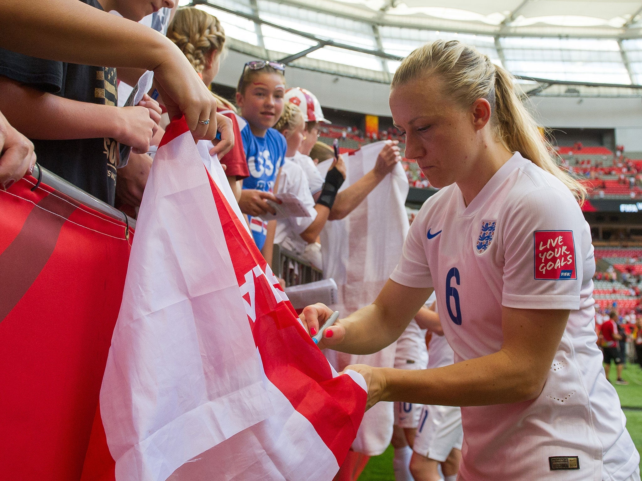 Laura Bassett signs autographs for England fans after the quarter-final victory