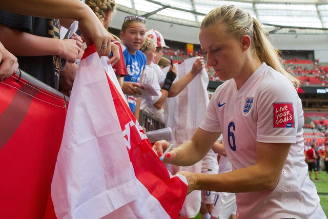 Laura Bassett signs autographs for England fans after the quarter-final victory