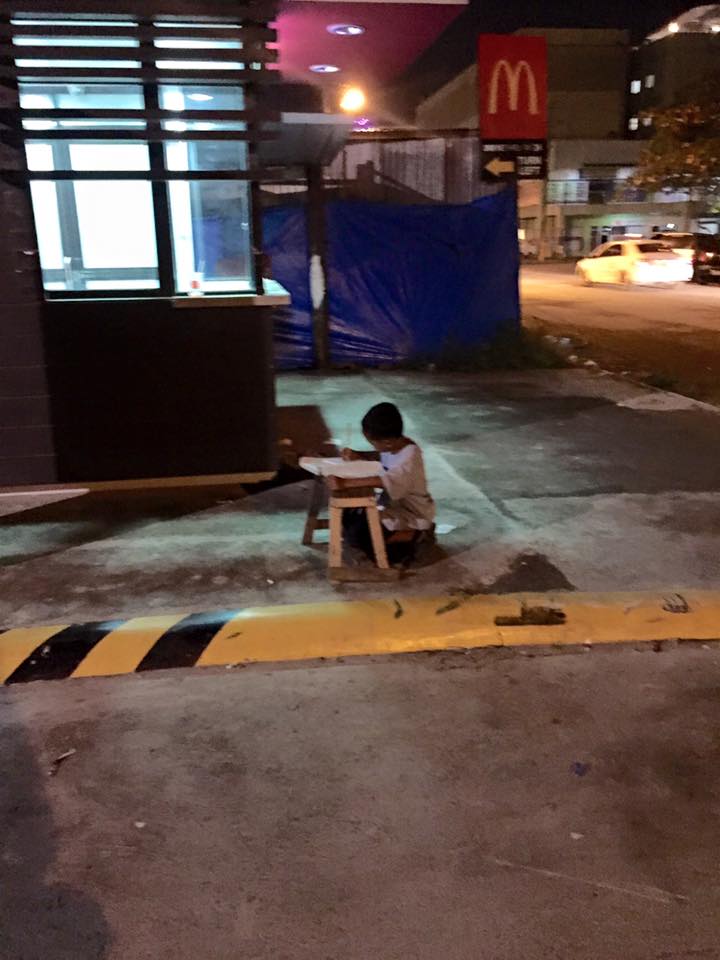 Little Daniel Cabrera needs the light from the restaurant's drive-thru to study