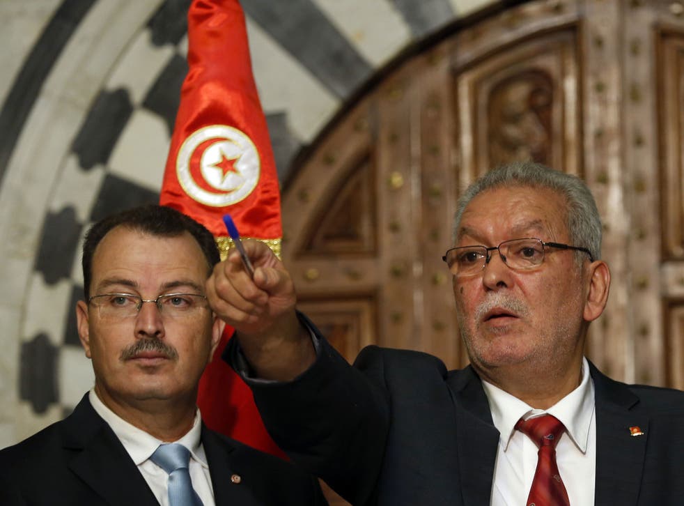 Kamel Jendoubi, Minister to the Prime Minister in charge of Relations with Constitutional Bodies and the Civil Society, right, gestures during a press conference in Tunis