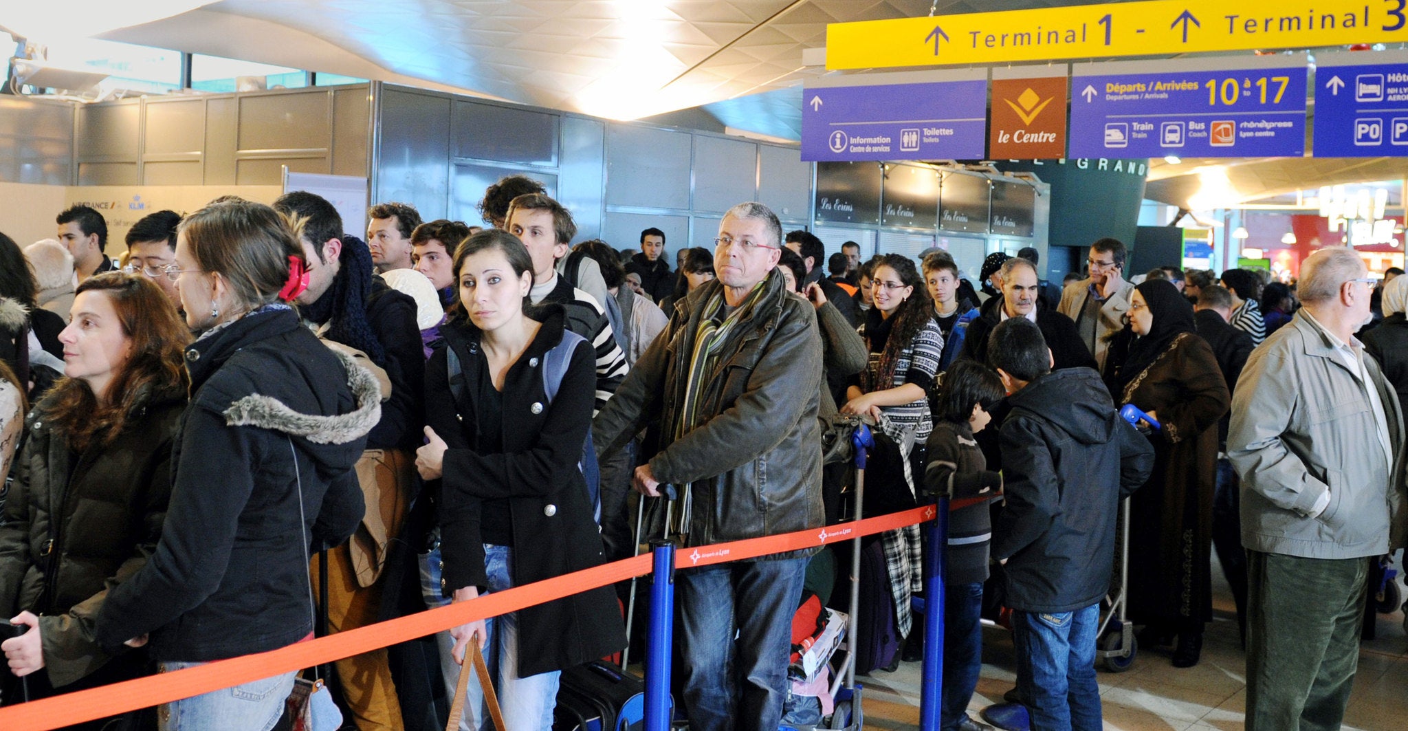 Passengers queue after flights have been cancelled at Saint-Exupery airport in the eastern city of Lyon.