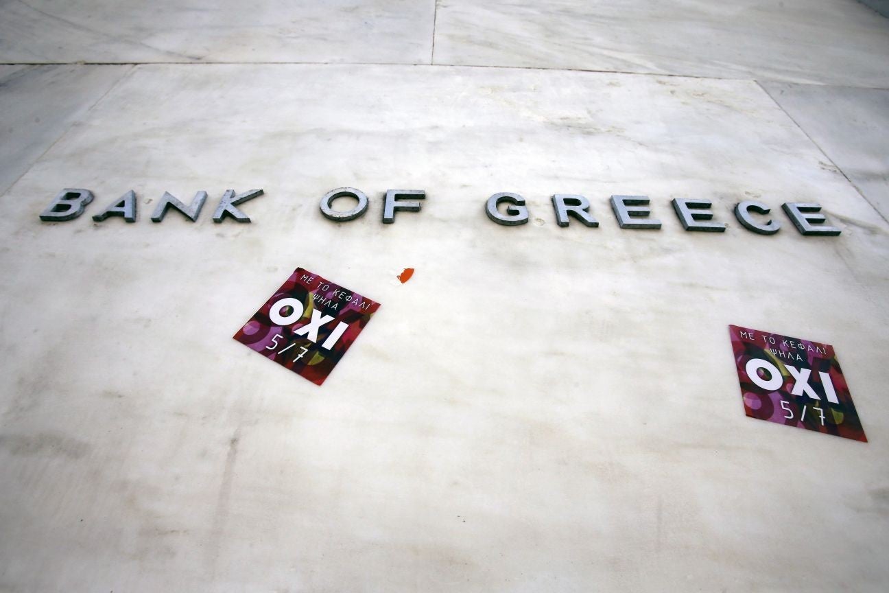 Stickers urging people to vote 'No' in the referendum adorn the wall of the Bank of Greece (AP)