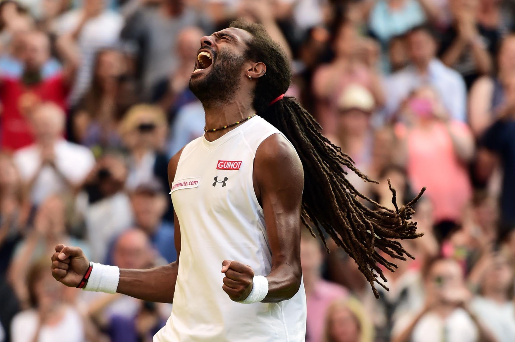 Dustin Brown celebrates victory over Rafael Nadal on day Four of the Wimbledon Championships