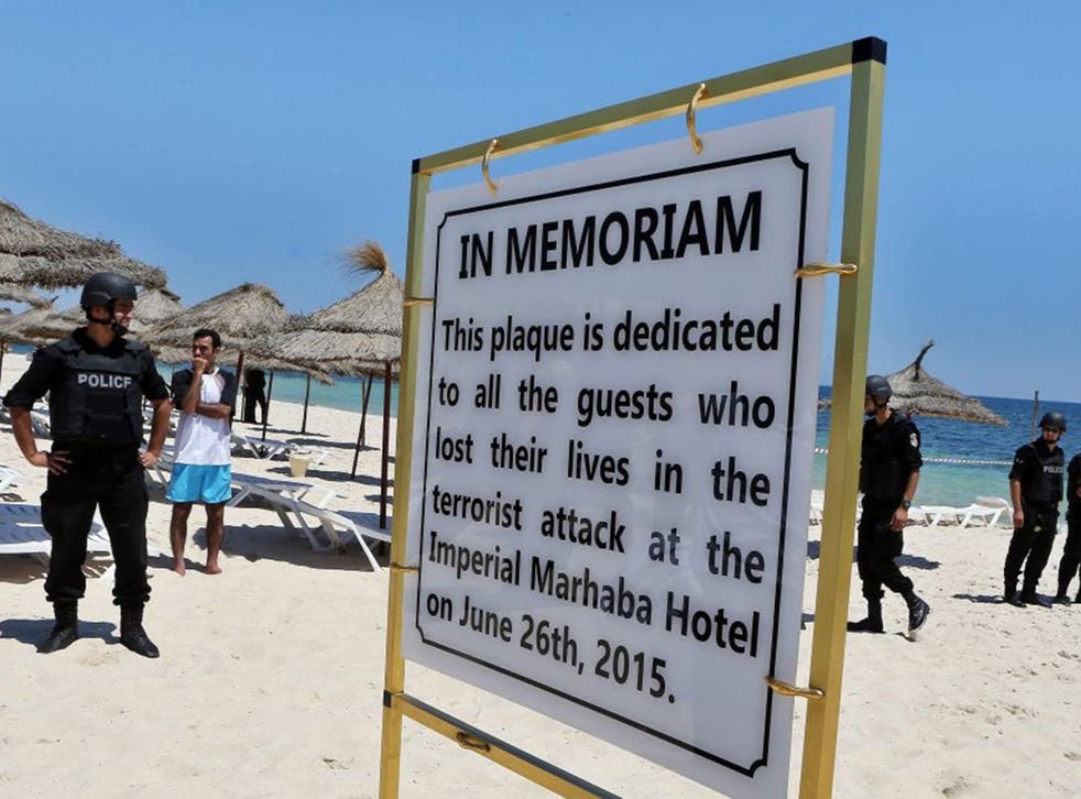 Members of the Tunisian security services stand guard during a memorial ceremony and minutes silence for the victims of a terror attack on a beach outside the Imperial Marhaba Hotel, in the popular tourist resort of Sousse, Tunisia