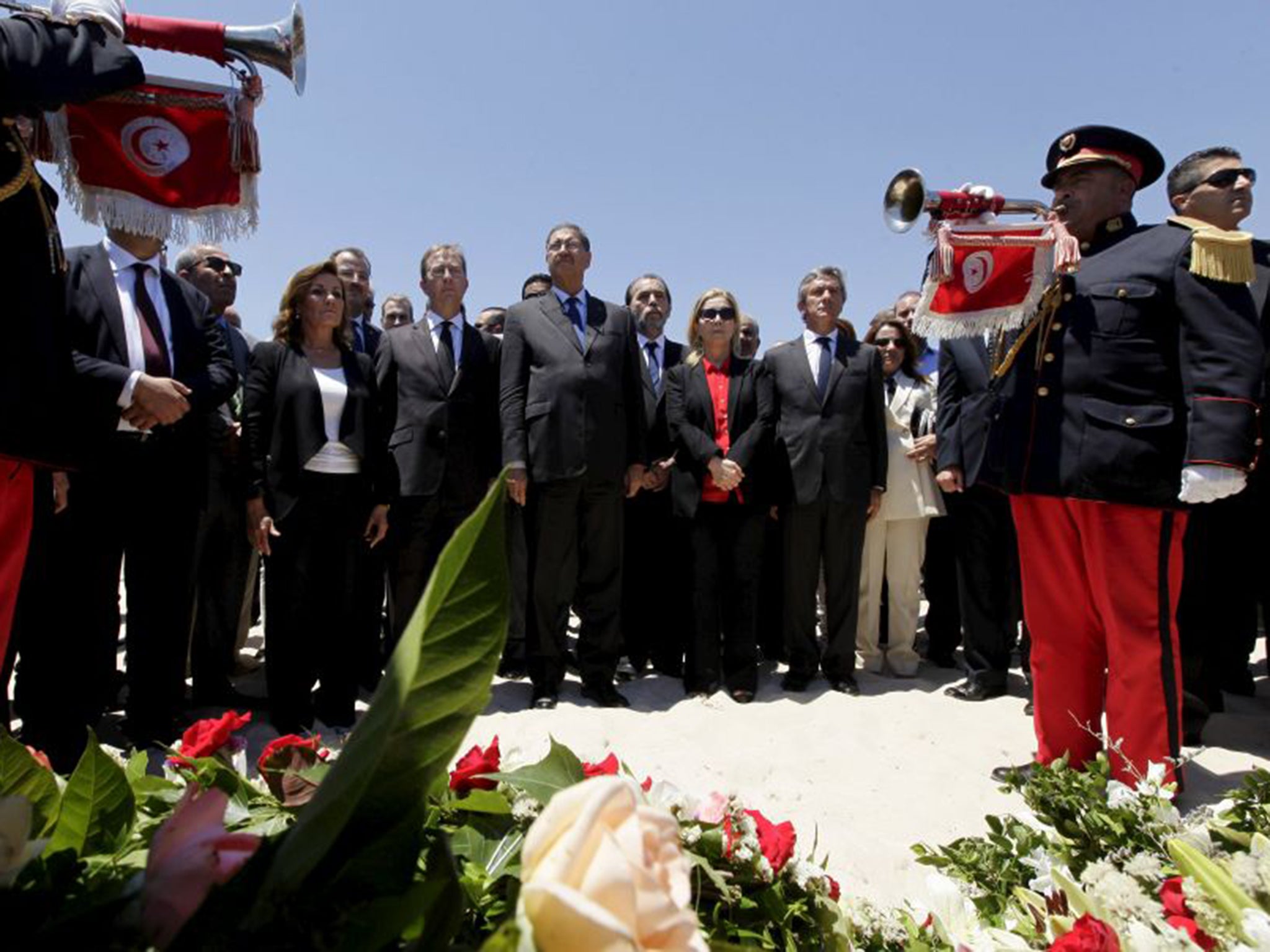 Tunisia’s Prime Minister Habib Essid, centre, observes a minute’s silence for the Sousse victims on Friday