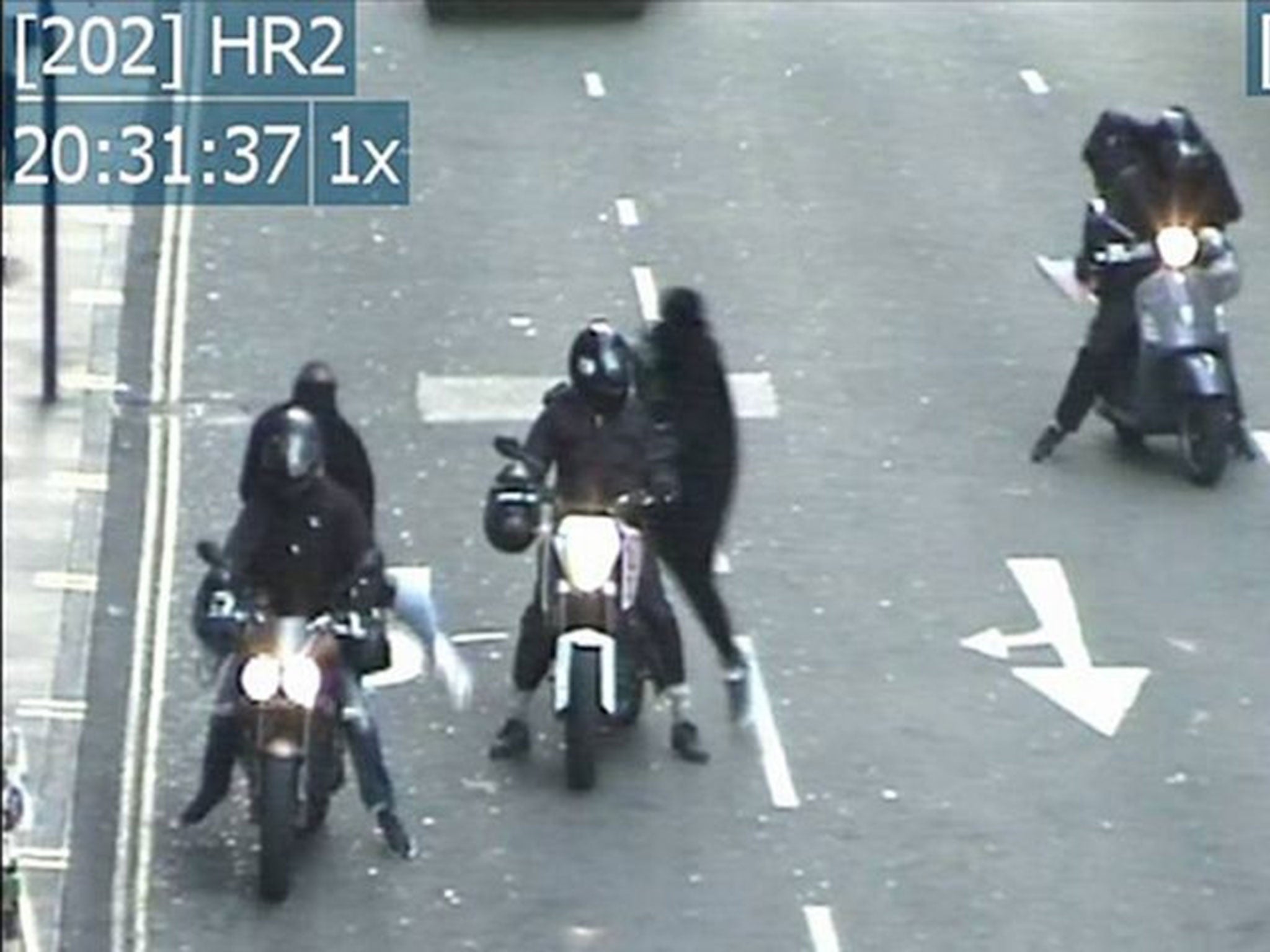 Members of the gang pictured taking part in a raid (Image: PA/Metropolitan Police)