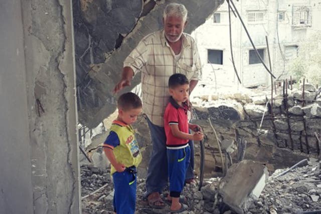 Rabah Abu Shanab, 47, in the ruins of his house in Shejaiya