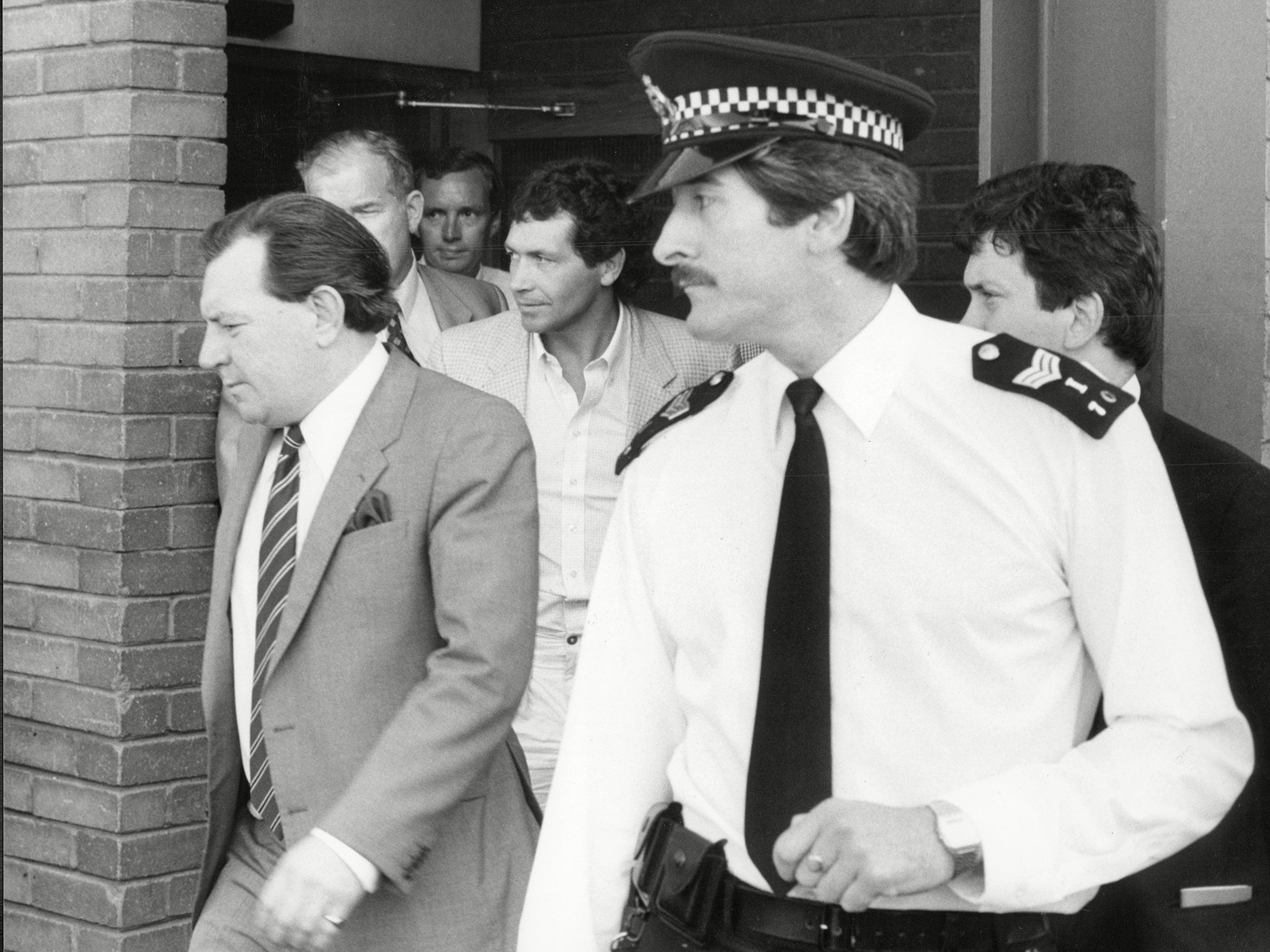 John Palmer surrounded by police as he is arrested in connection with the Brink’s-MAT bullion raid at Heathrow airport, in 1983