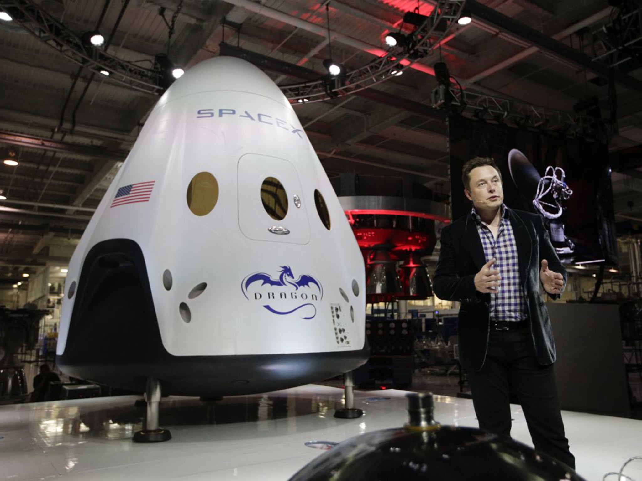 Elon Musk with a SpaceX capsule – the kind that will carry him away to Mars if his plans for robots go wrong