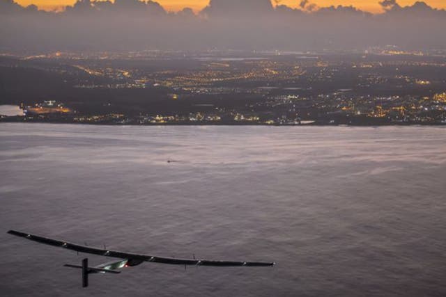 The Solar Impulse 2, powered by the sun's rays, approaches Kalaeloa Airport near Honolulu on Friday