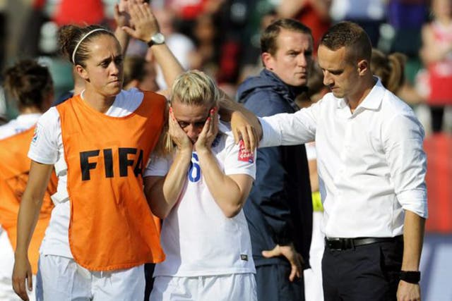 England coach Mark Sampson consoles a tearful Laura Bassett, centre, after their semi-final defeat to Japan
