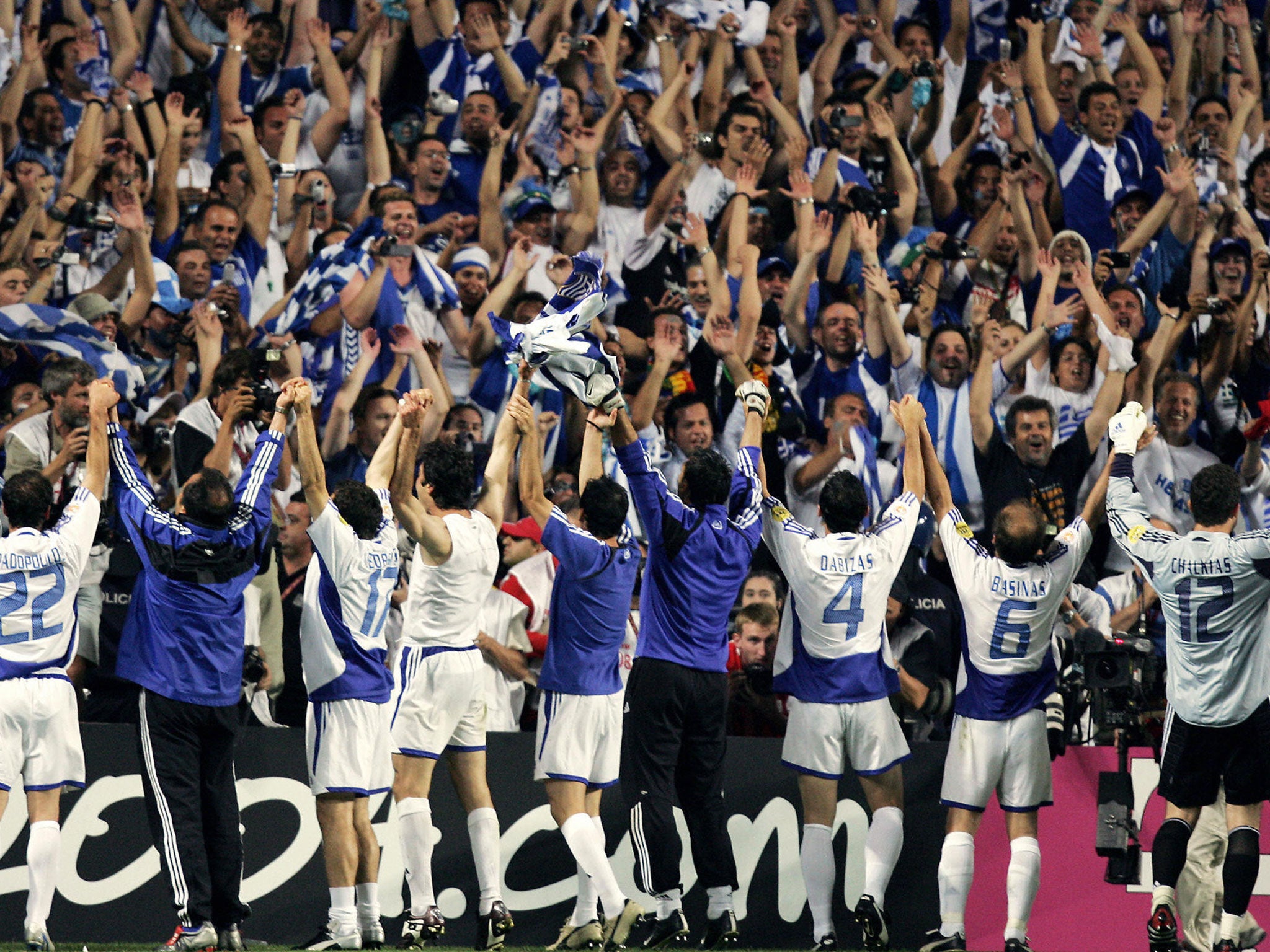The players and fans of Greece celebrate as one