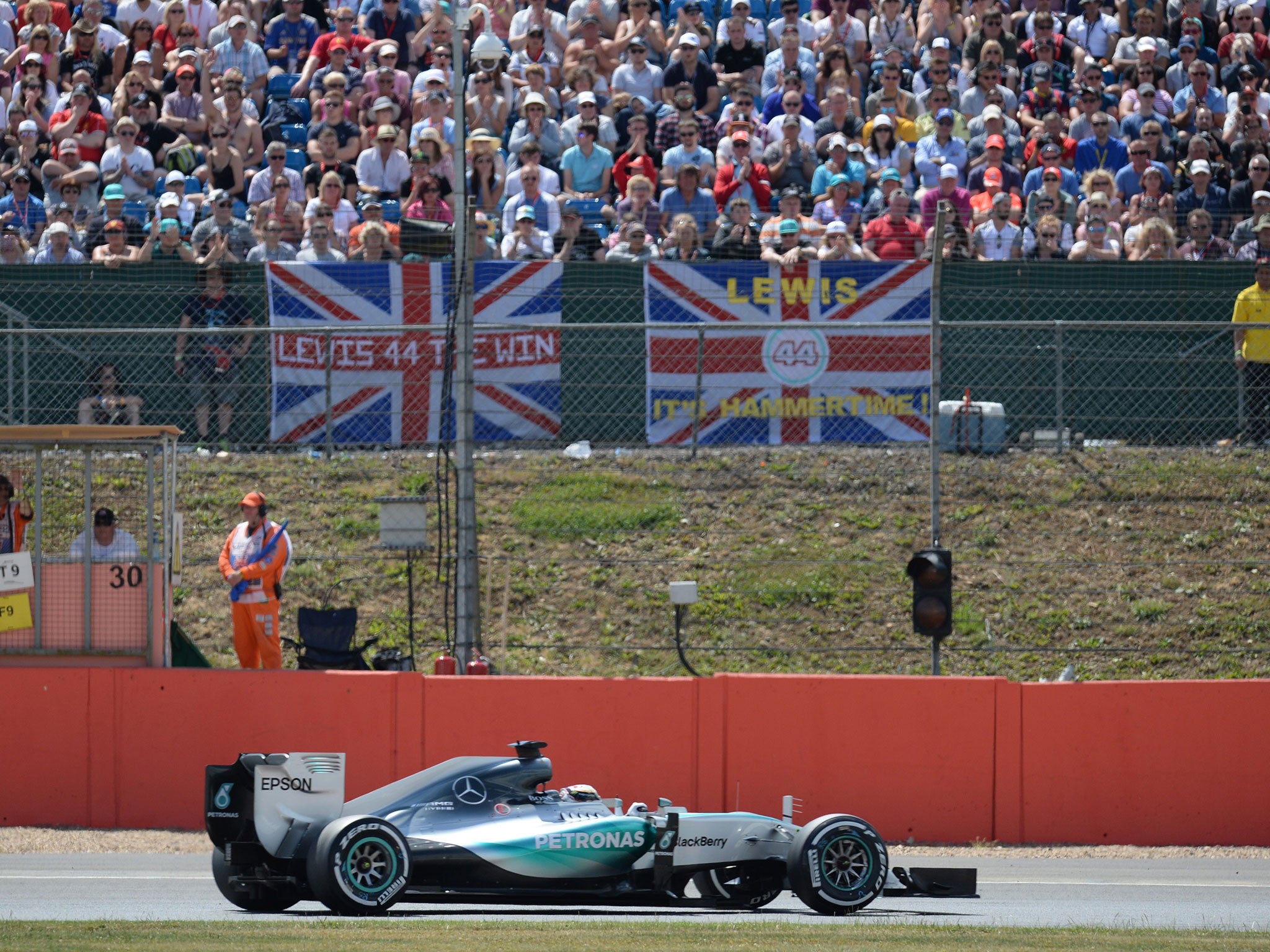 Lewis Hamilton takes pole on front of his home fans