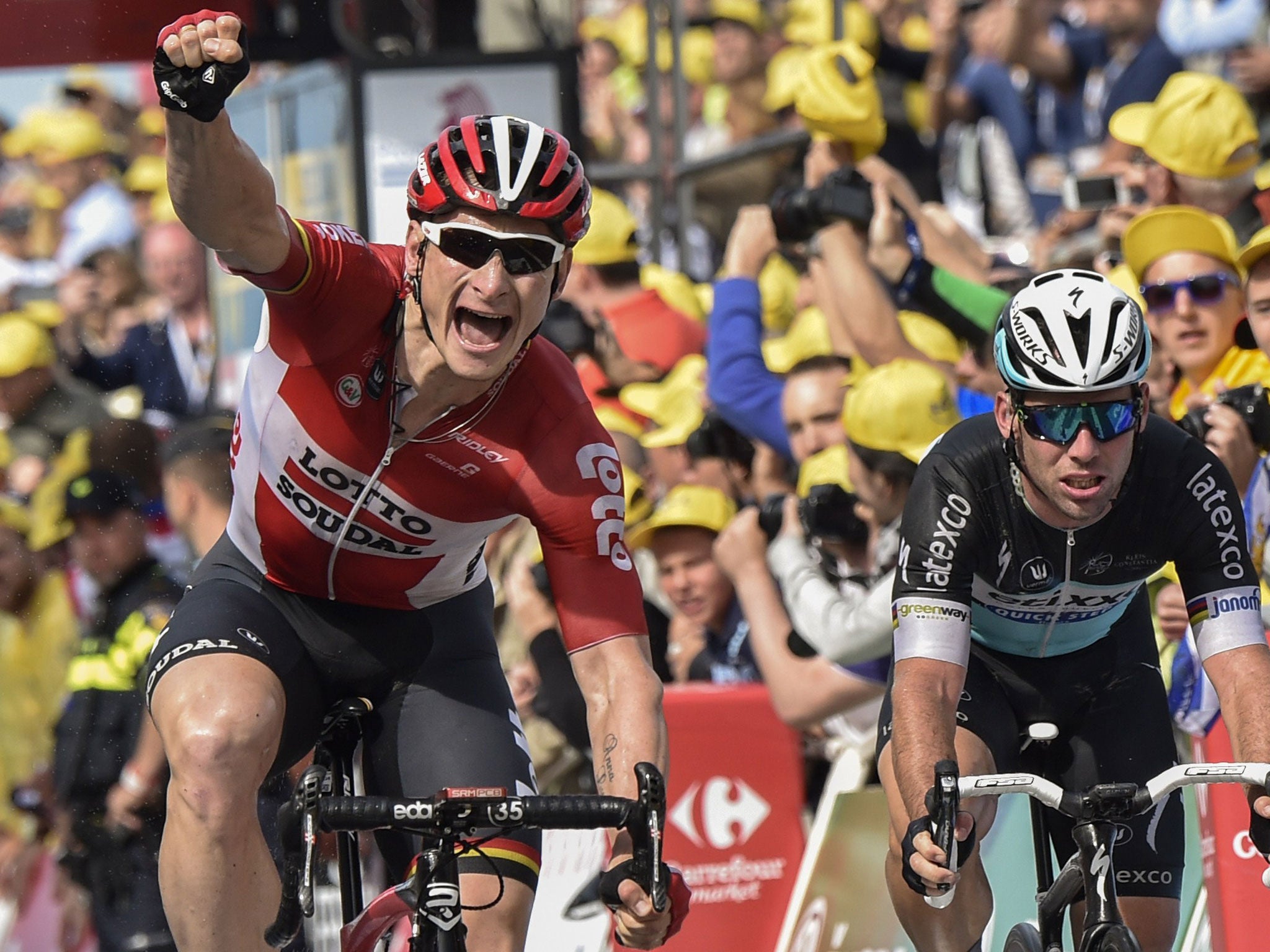 Andre Greipel (left) celebrates as he crosses the finish line on stage two ahead of Great Britain's Mark Cavendish