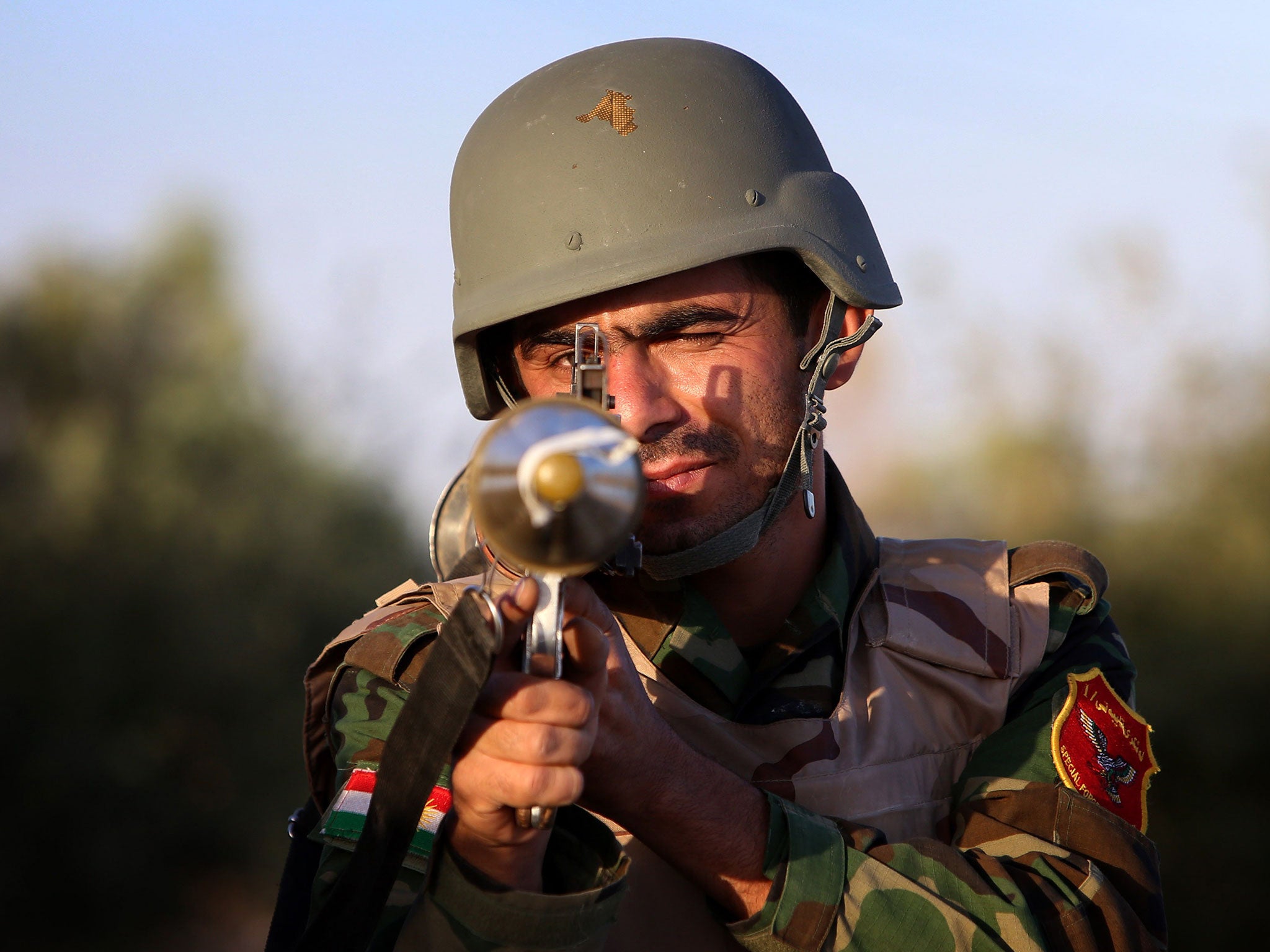 A Kurdish Peshmerga fighter poses with his weapon on the front line in Makhmur, Iraq. The Peshmerga are fighting to protect Kurdistan – something volunteers may not fully appreciate, they say