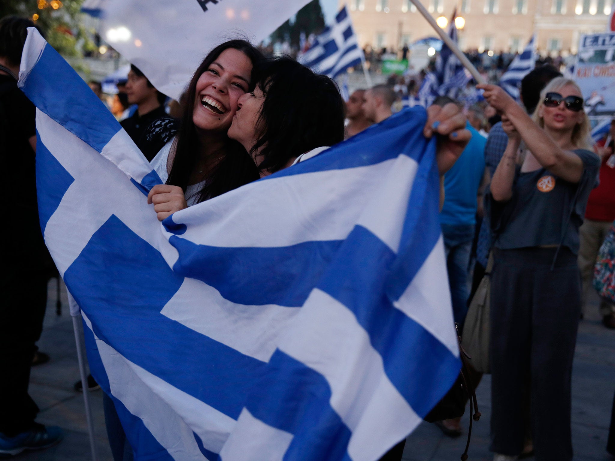 Supporters of the No vote react after the first results of the referendum at Syntagma square in Athens