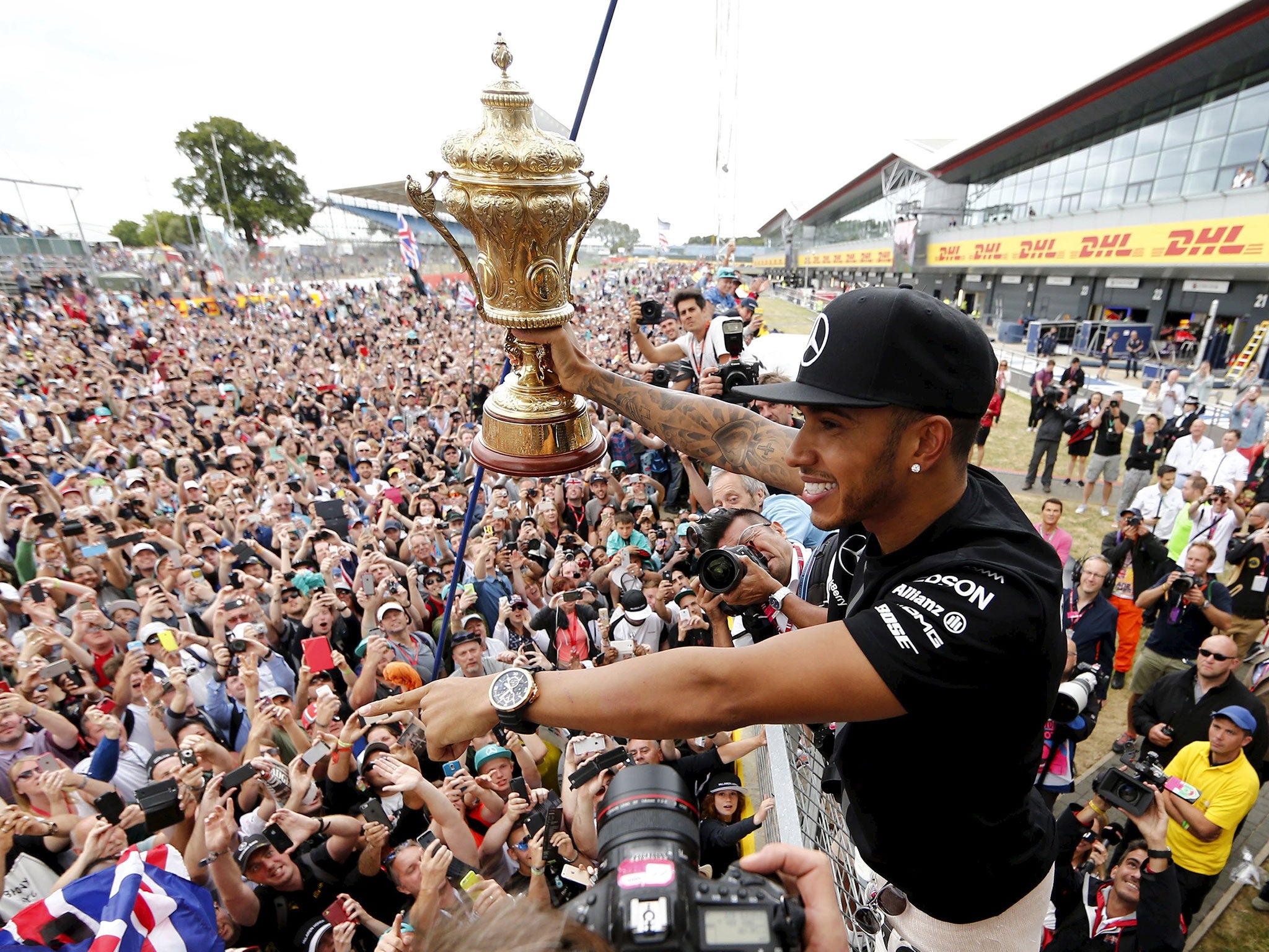 Lewis Hamilton shows his delighted fans the British Grand Prix trophy after his victory at Silverstone