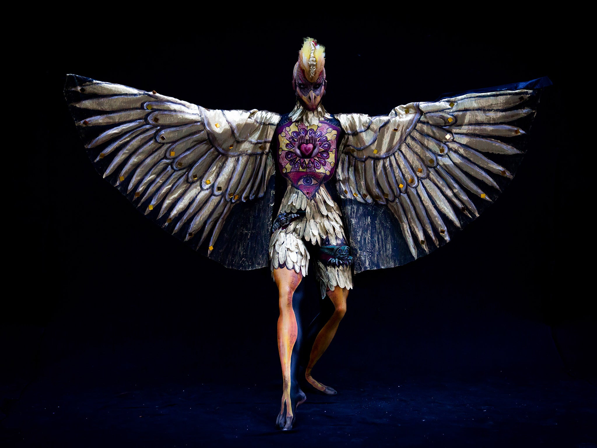 Extravagant feathers adorn this model's bird-like outfit