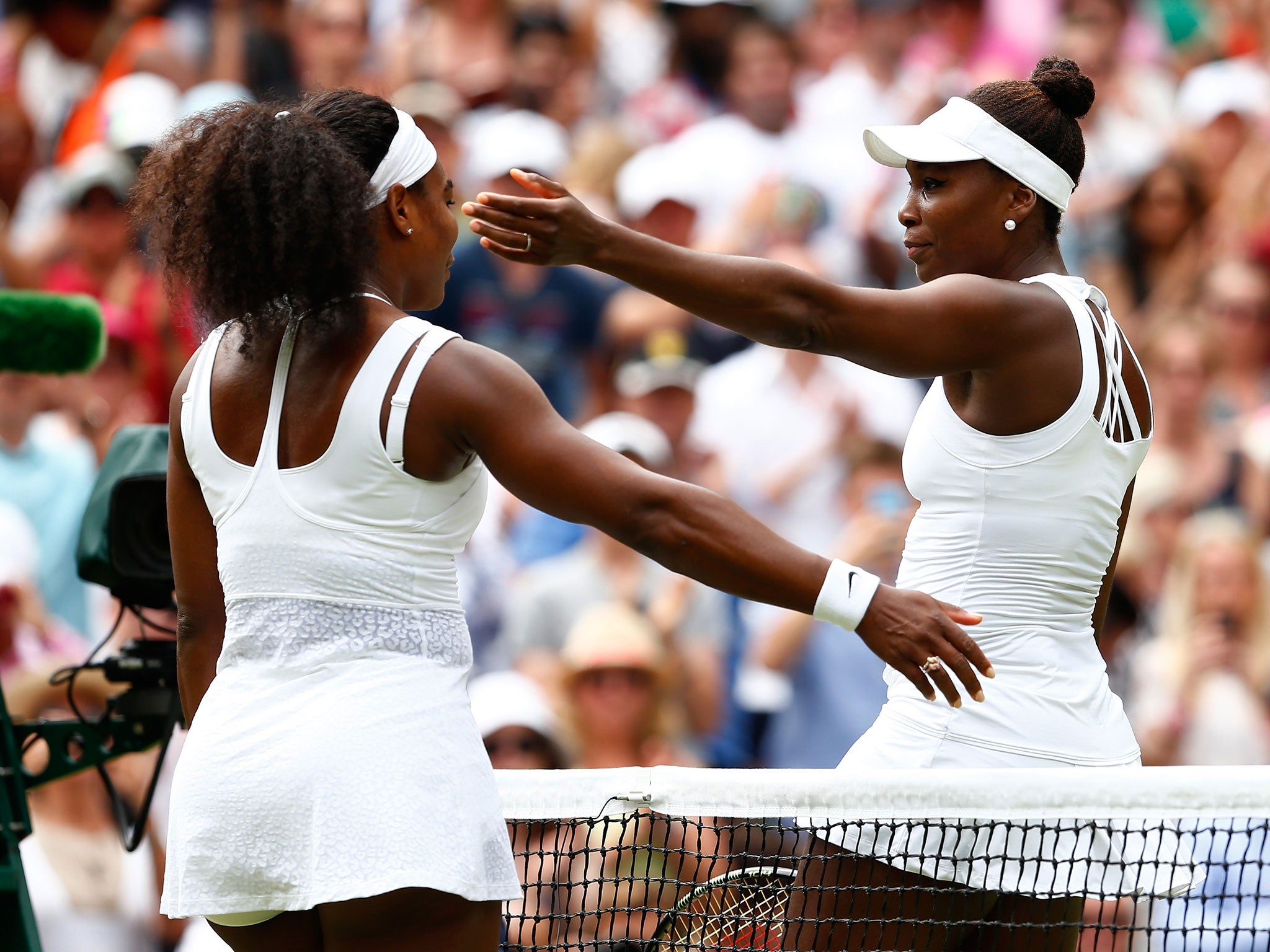 Serena is congratulated by sister Venus after their fourth round contest