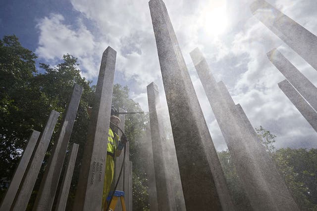 A memorial dedicated to the 52 people that were killed during the 7/7 terror attacks in London is cleaned in London's Hyde Park