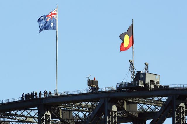 The Australian Aboriginal Flag, right, flies alongside the Australian National Flag on the top of the Sydney harbour bridge 