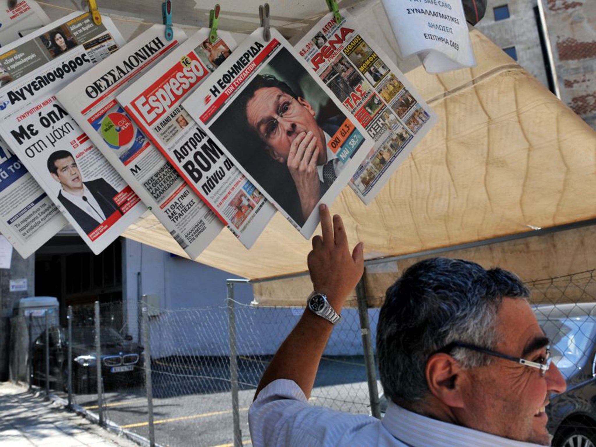 The front page headlines report the results of Greece's referendum, on sale at a kiosk in Thessaloniki