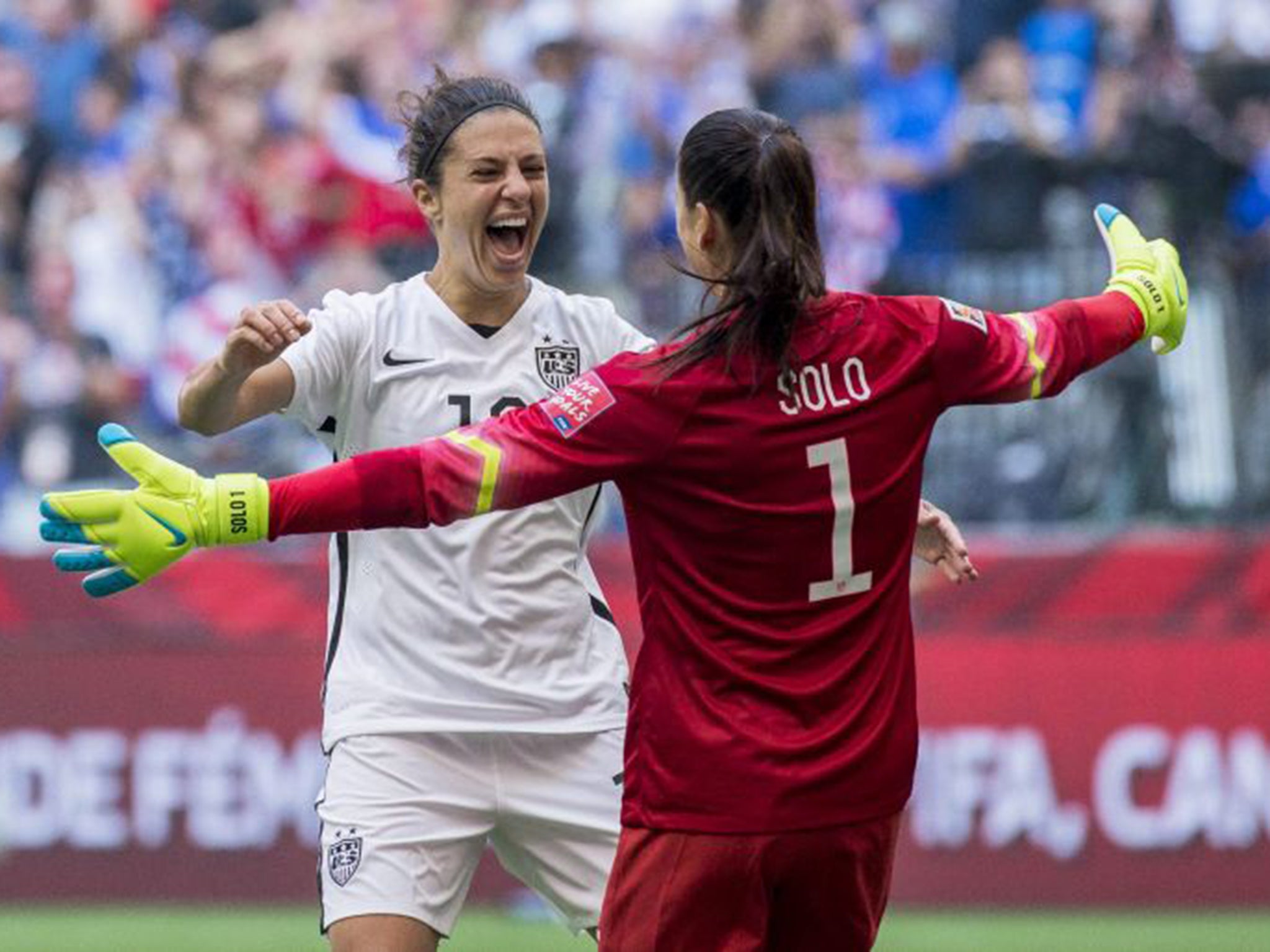 Carli Lloyd celebrates with US goalkeeper Hope Solo after the final victory