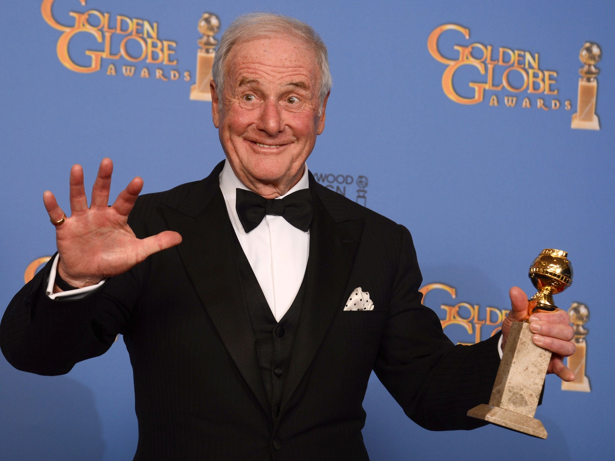 Jerry Weintraub poses in the press room with the award for best mini-series or motion picture made for television for "Behind the Candelabra" at the 71st annual Golden Globe Awards in Beverly Hills