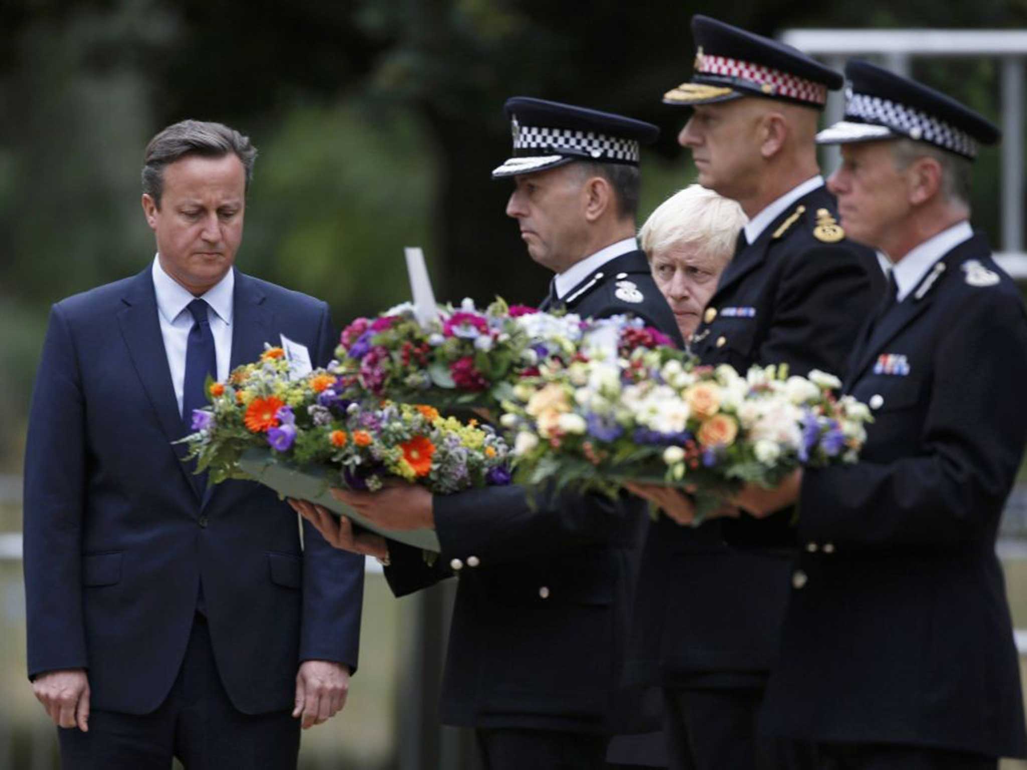 David Cameron and London Mayor Boris Johnson watch the servicemen lay wreaths in Hyde Park