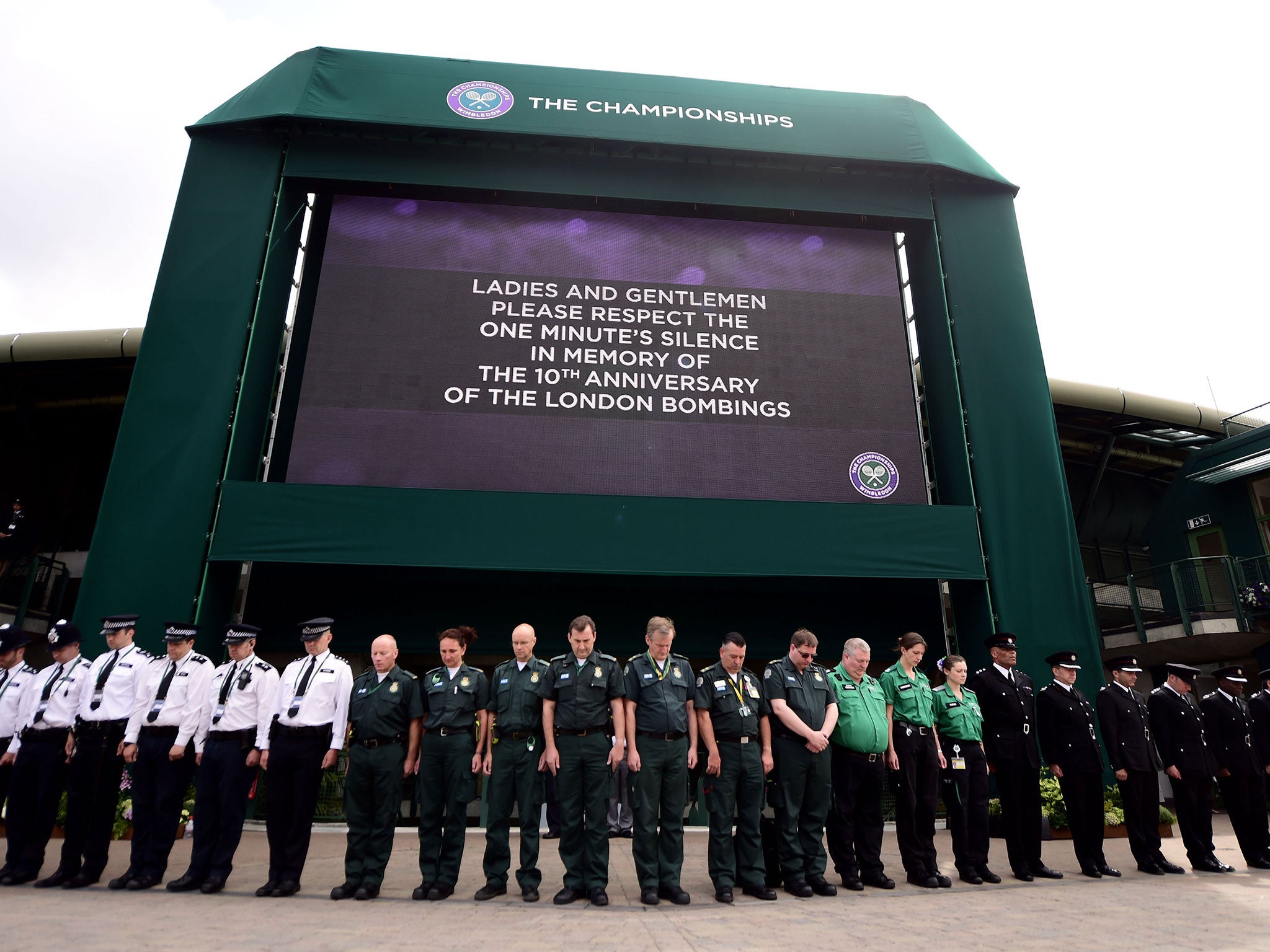 Members of staff working within the grounds observe a minutes silence to commemorate the tenth anniversary of the July 7 terrorist attacks at the All England Lawn Tennis and Croquet Club, Wimbledon