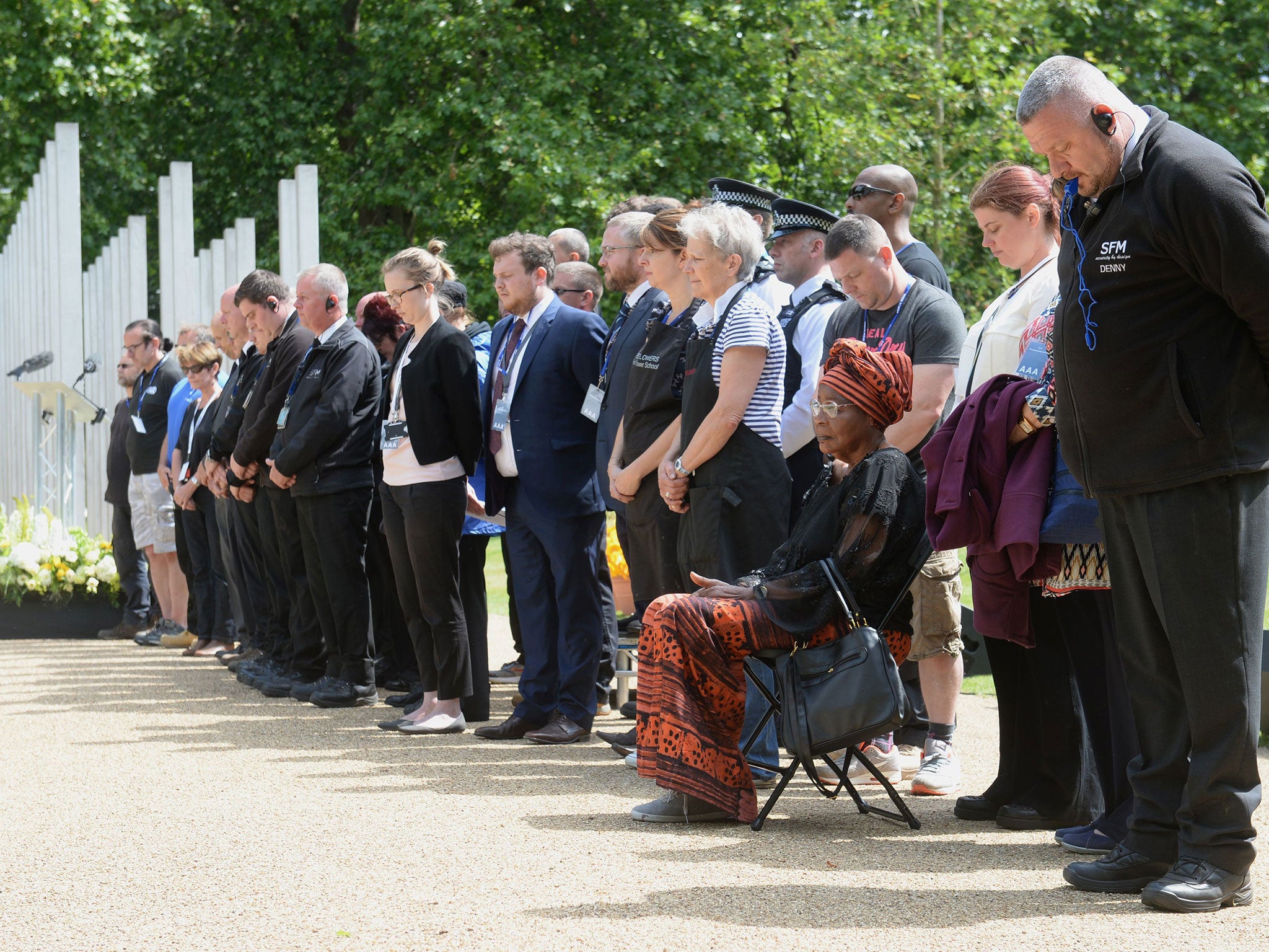 Security staff and workers from Hyde Park observe a minutes silence at the 7/7 memorial in Hyde Park