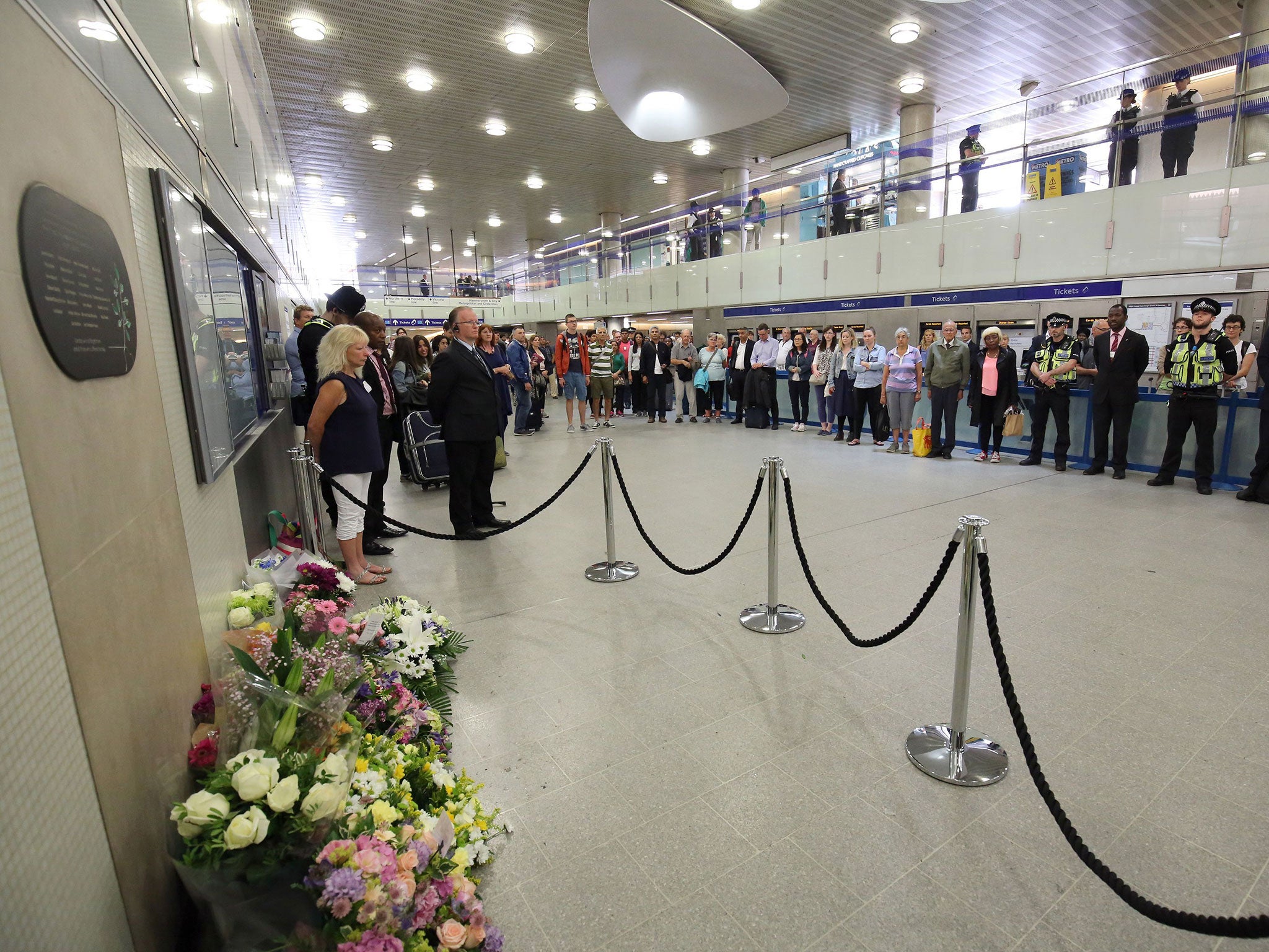 People pause for a minutes silence at Kings Cross Underground station