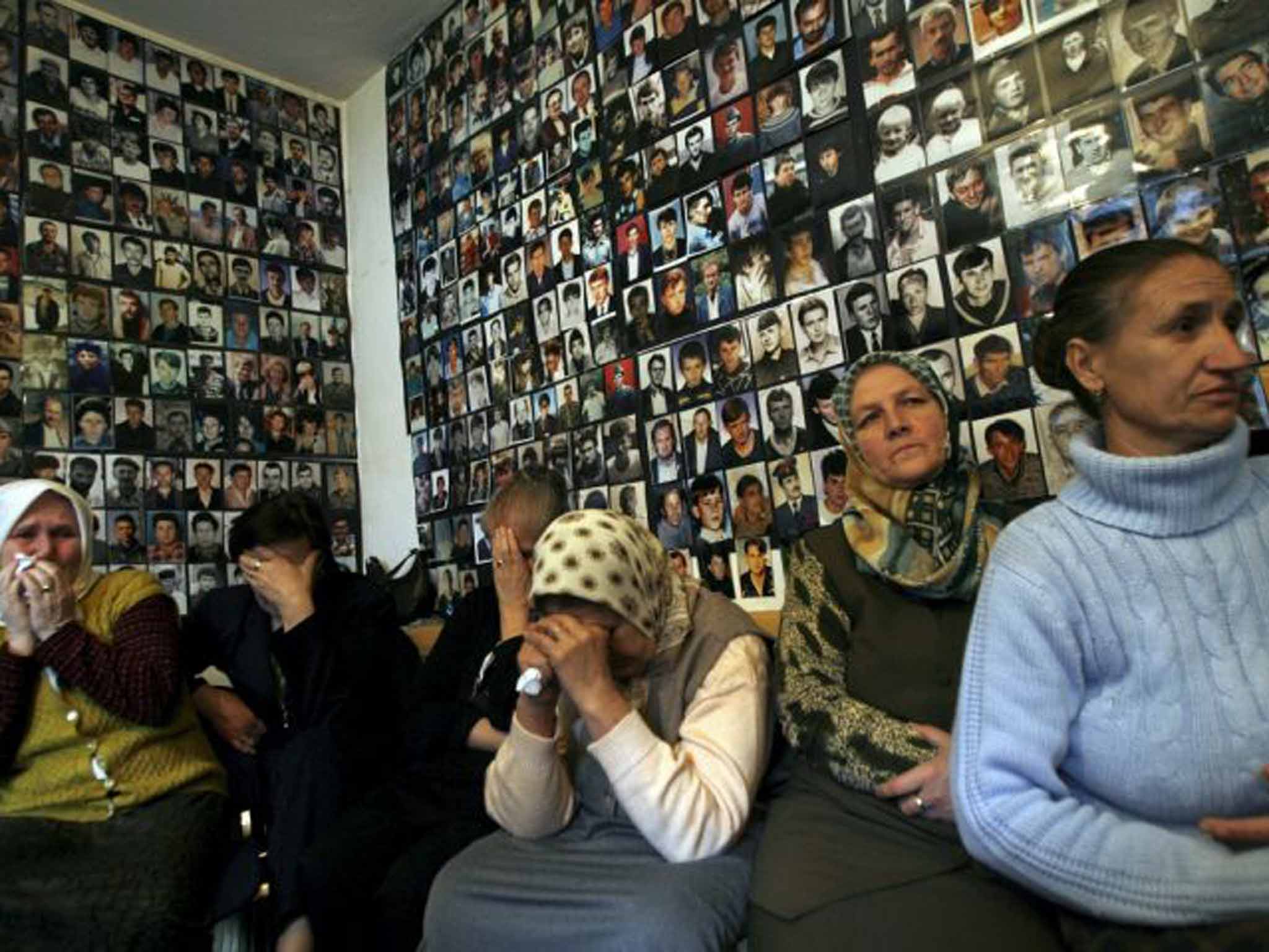 Gone but not forgotten: women from Srebrenica with pictures of their missing loved ones