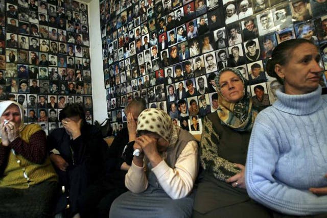 Gone but not forgotten: women from Srebrenica with pictures of their missing loved ones