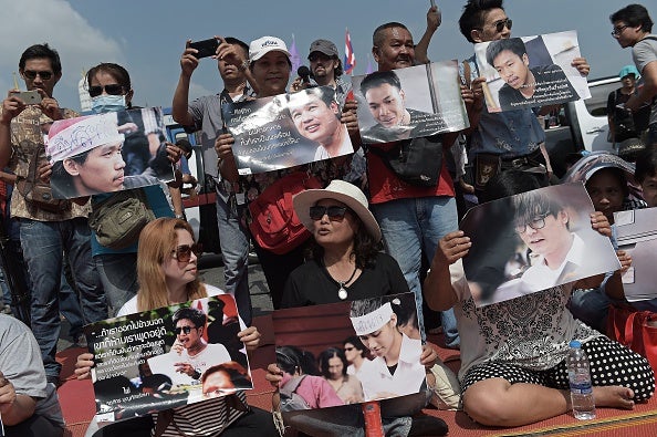 Supporters held pictures of the detained students as they took part in a protest in their support outside the cordoned-off military court where they appeared before release
