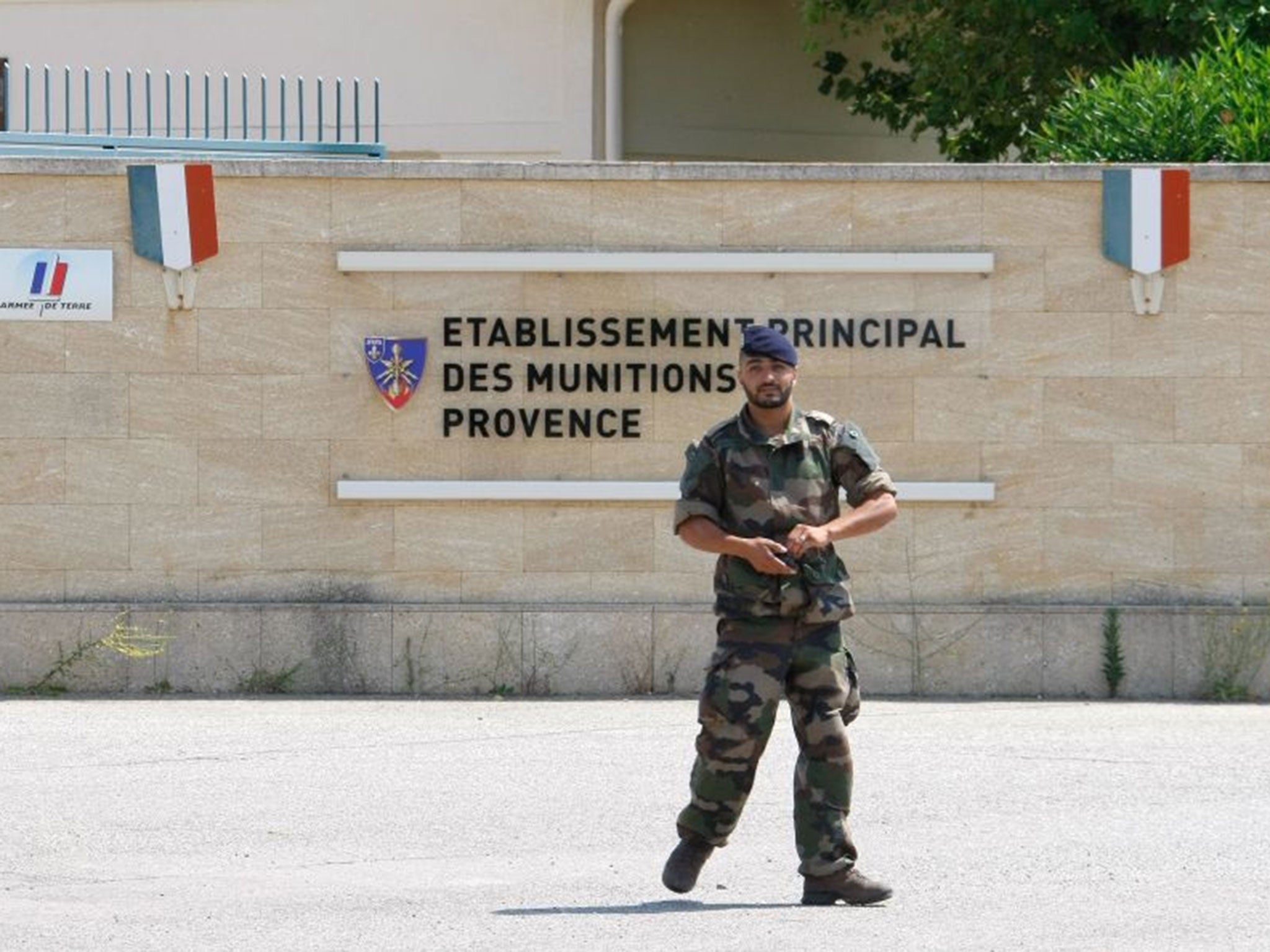 A soldier walks outside the weapons stocks military base in Miramas , southern France, Tuesday, July 7, 2015. French authorities are investigating the theft of roughly 200 detonators plus grenades and plastic explosives from the military site. The break