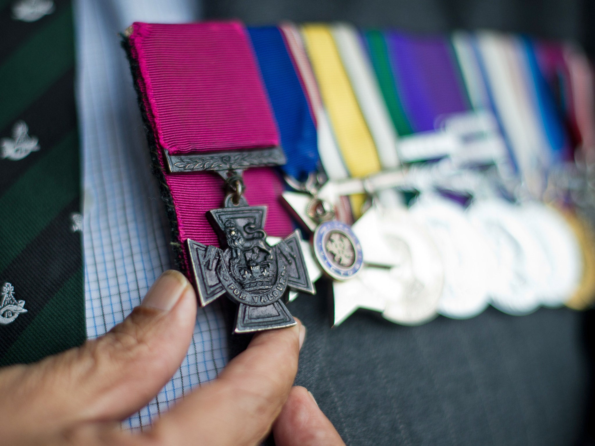 A Victoria Cross recipient handles the award on his lapel. File photo