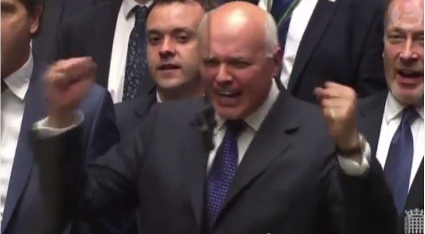 Iain Duncan Smith can hardly control his emotion as George Osborne announces the introduction of a compulsory national minimum wage