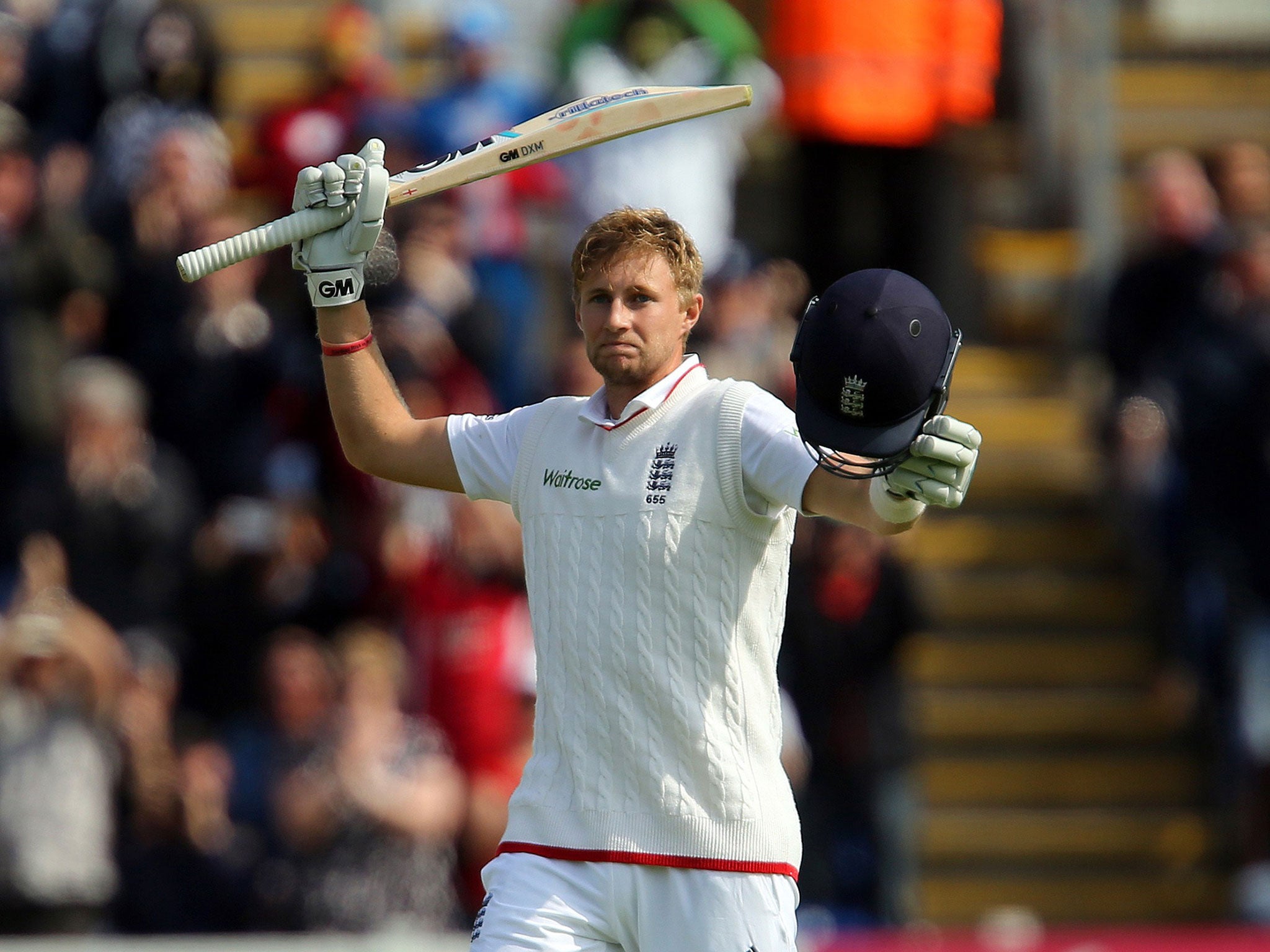 Joe Root raises his bat as he celebrates his ton