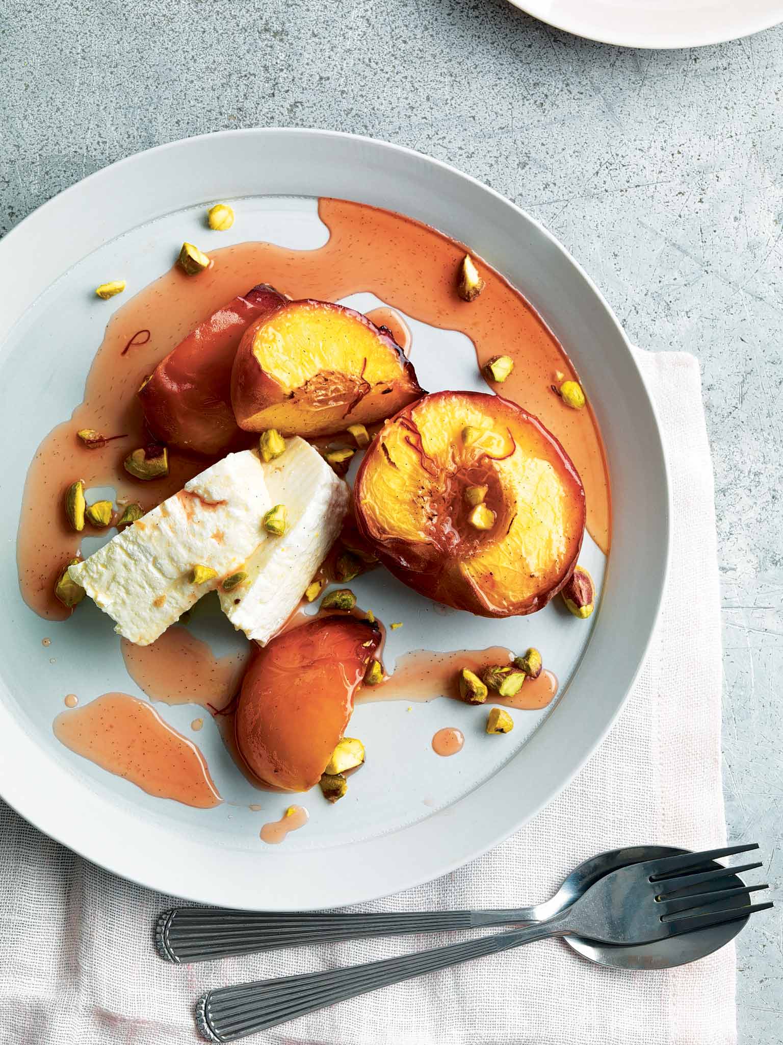 Saffron-roasted peaches with ricotta and pistachios