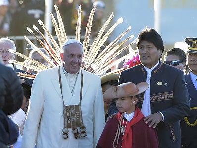 Pope Francis and Bolivian President Evo Morales walk with Bolivian native children