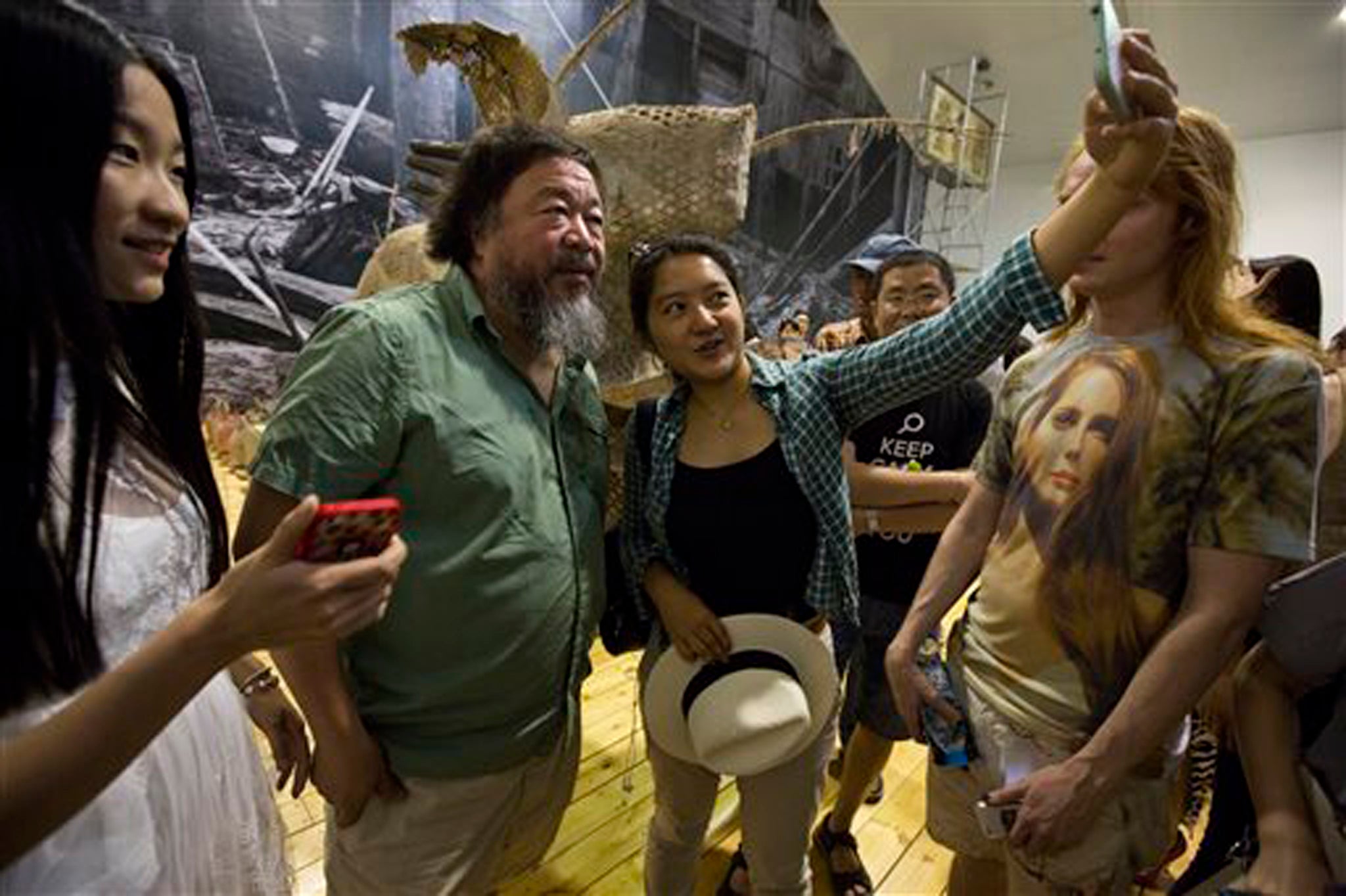 Ai poses with exhibition-goers at his latest show