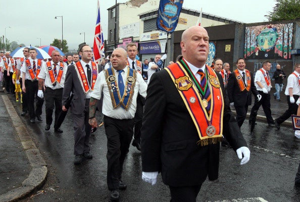 Loyalists of the Orange Order march past the nationalist Ardoyne area of North Belfast, in Northern Ireland, on July 12, 2014