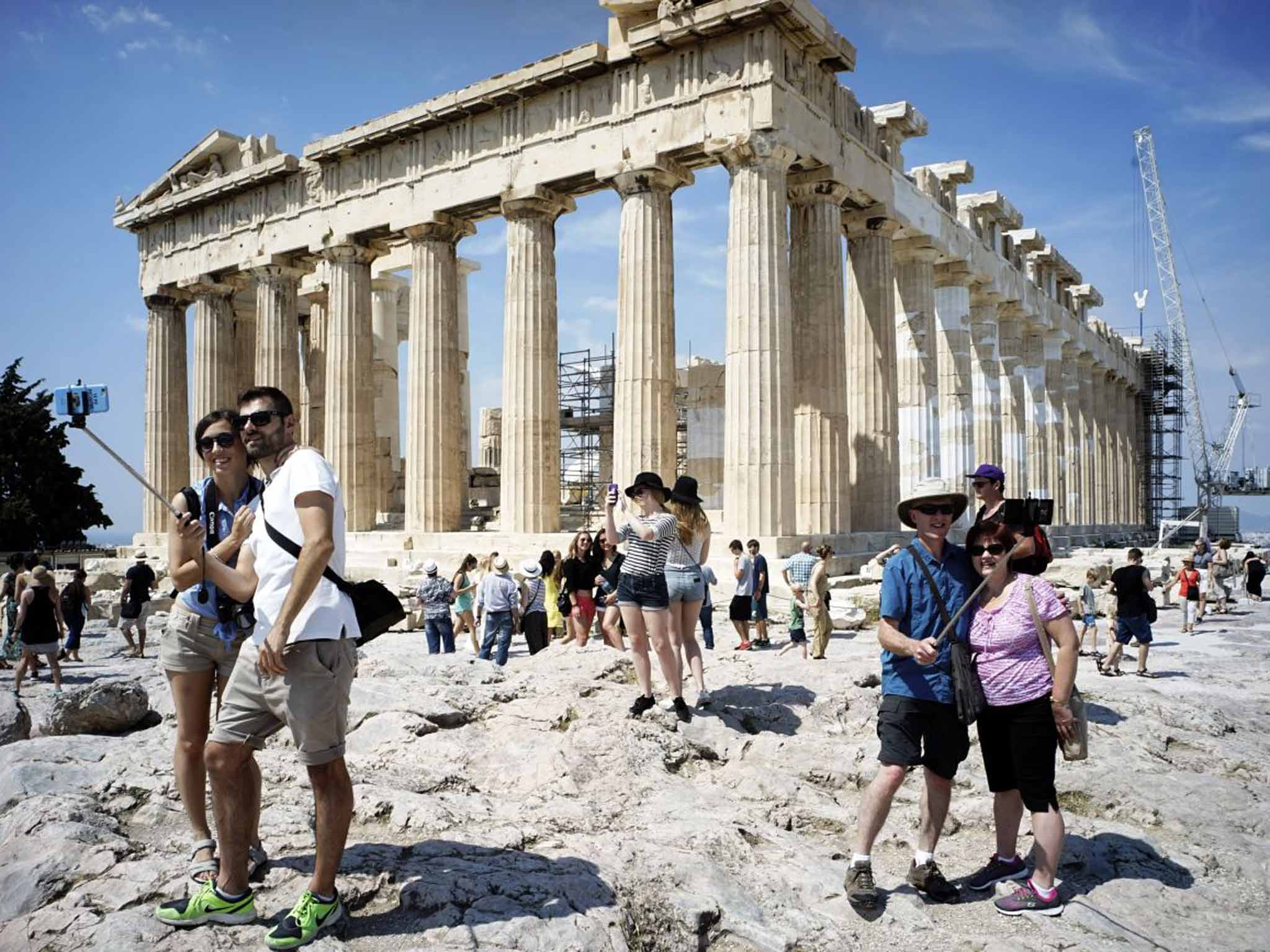 Smile for the camera: tourists should still enjoy holidays to Greece this summer