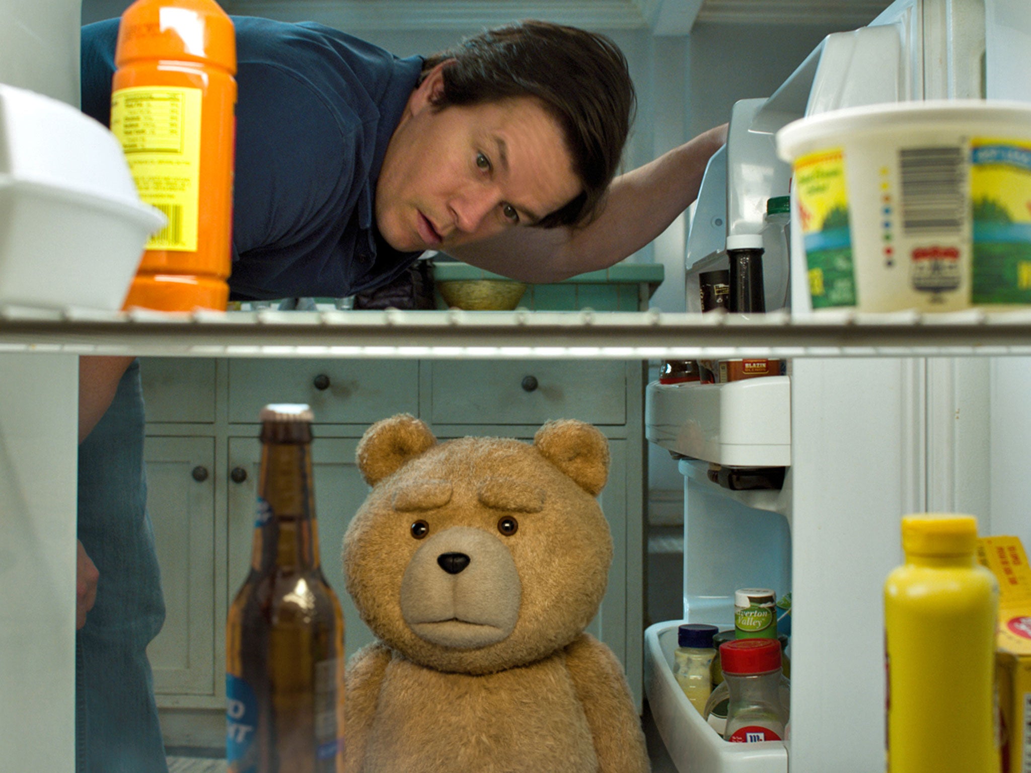 Mark Wahlberg and furry friend (voiced by Seth MacFarlane) raid the fridge for supplies in ‘Ted 2’