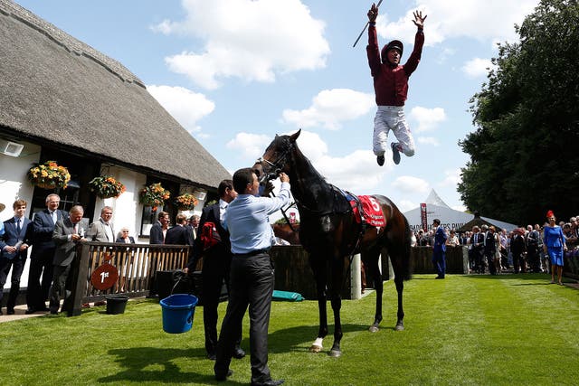 Frankie Dettori performs his flying dismount after winning the opener at Newmarket’s July Course on Mr Singh
