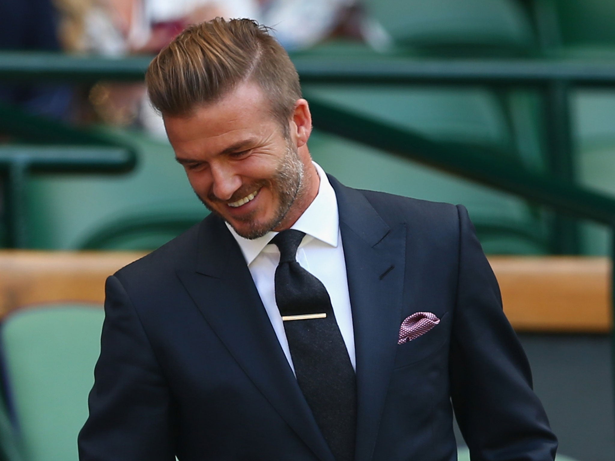 David Beckham couldn't help but smile after catching a ball during a game