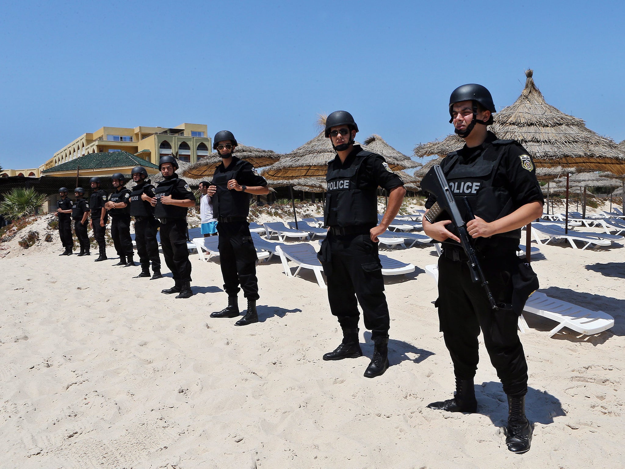 Members of the Tunisian security services stand guard during a memorial ceremony and minutes silence for the victims of the Sousse terror attack