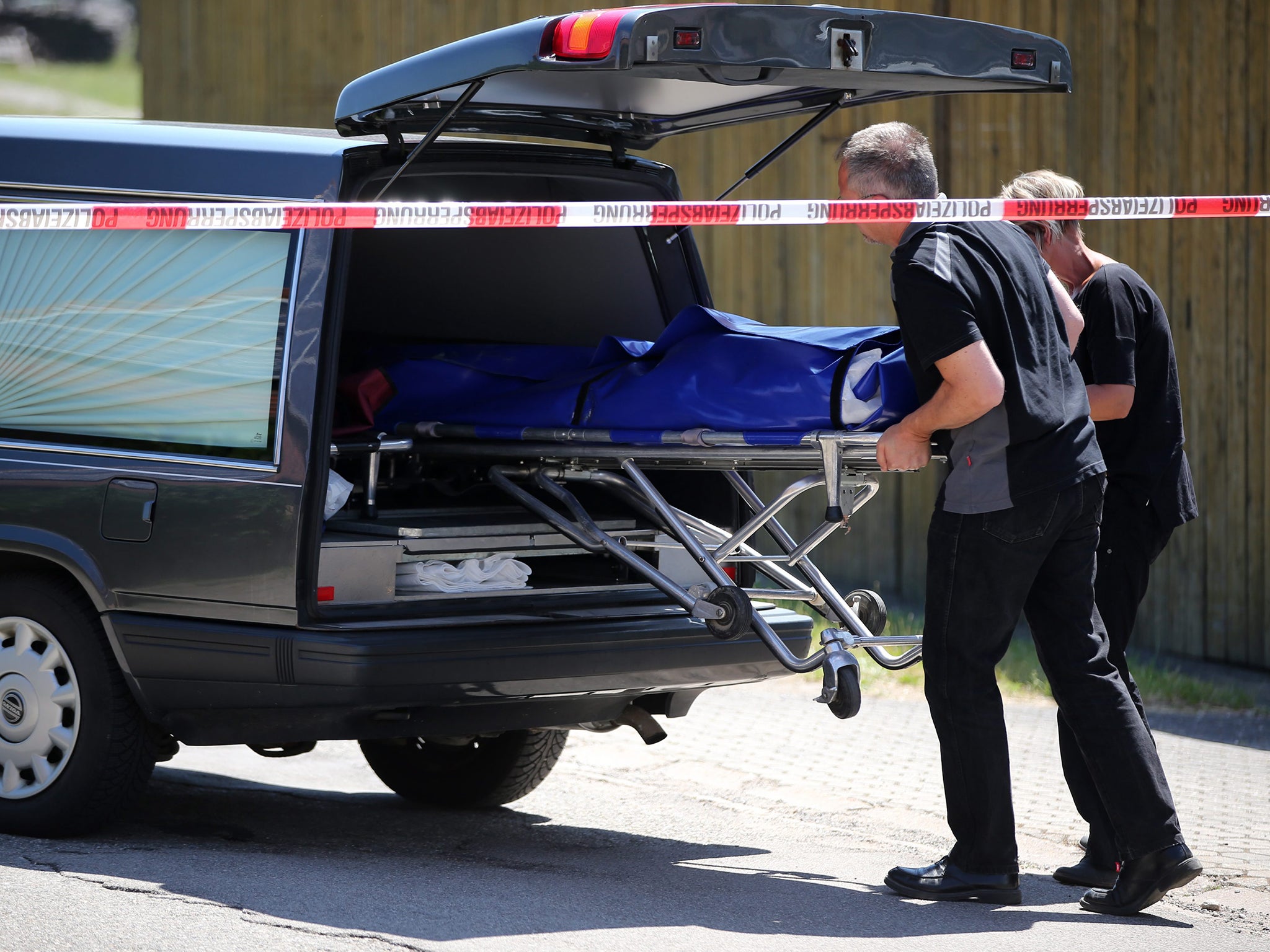 Undertakers load a stretcher with one of the victims into a hearse in Leutershausen, near Ansbach in Bavaria, Germany