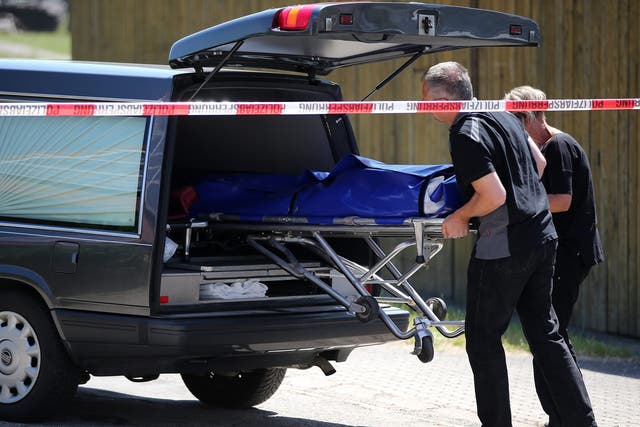 Undertakers load a stretcher with one of the victims into a hearse in Leutershausen, near Ansbach in Bavaria, Germany
